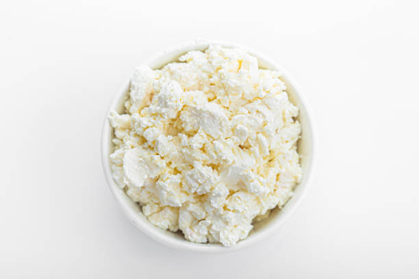 istock in a white plate, crumbly cottage cheese on an isolated white background 1281578443