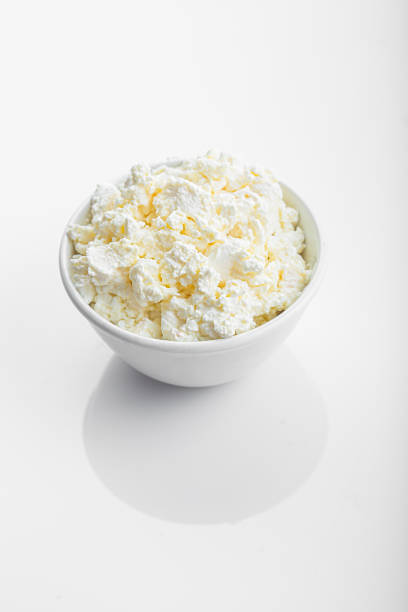 istock in a white plate, crumbly cottage cheese on an isolated white background 1281578444