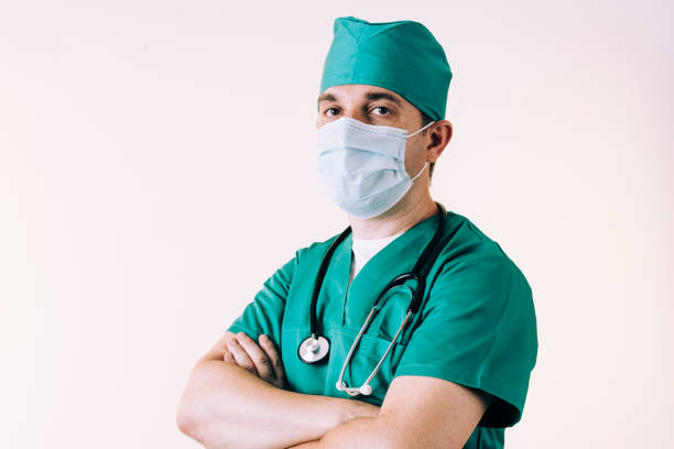 istock Young man doctor in uniform posing in studio 1281579329