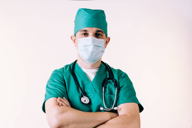 istock Young man doctor in uniform posing in studio 1281579339