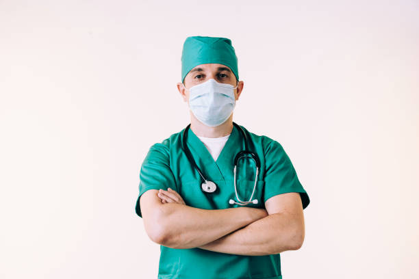 istock Young man doctor in uniform posing in studio 1281579350