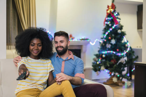 istock Lovely couple watching television at home 1281581442