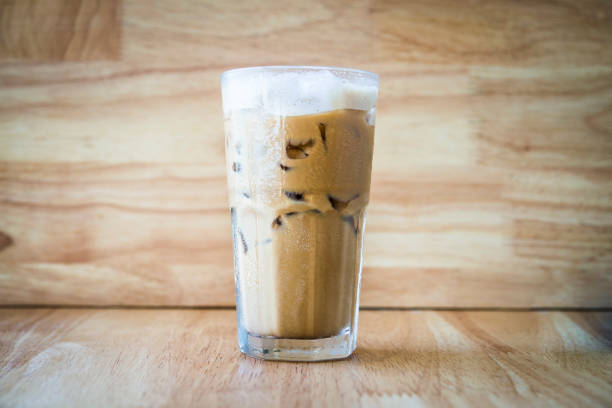 Iced coffee on a wooden table with a wood background