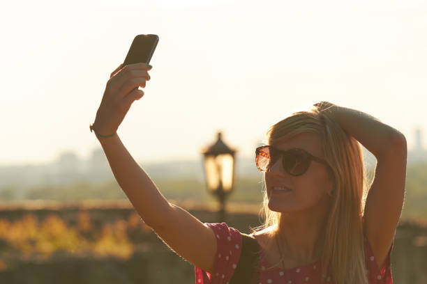 istock Young woman using modern smartphone in urban surroundings. 1281587222
