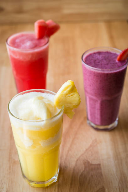 istock three different Fruit shakes, watermelon, pineapple and mixed berry on a pine wood background 1281587799