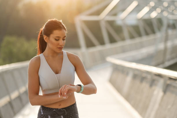 istock Sporty woman timing workout 1281587803