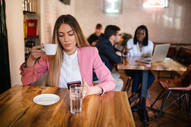 istock Modern young real estate agent typing down a e-mail on her mobile phone so she can be in contact with her clients 1281587909