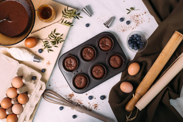 istock cupcakes with cream and blueberries on kitchen table 1281588212