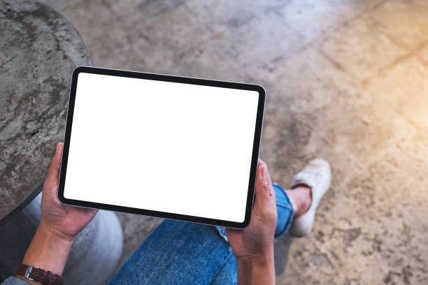 istock a woman holding digital tablet with blank white desktop screen 1281588444