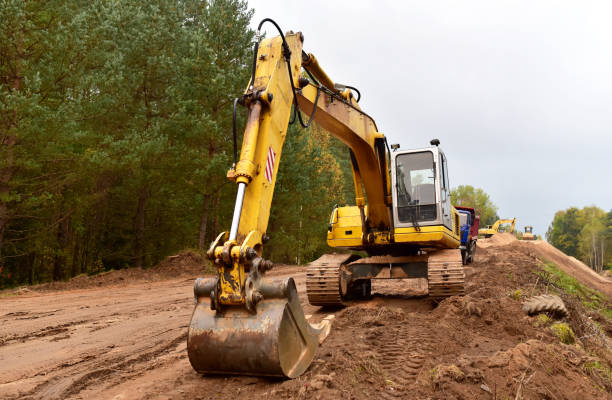 istock Excavator during construction new road in forest area. Yellow backhoe at groundwork. 1281591164