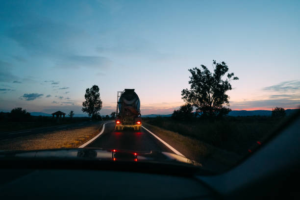 istock Road Against Sky And Cement Truck Seen Through Car Windshield 1281591219