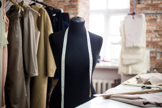 istock Design studio concept. Mannequin dummy, clothes hangers, dressmaking workplace 1281591469