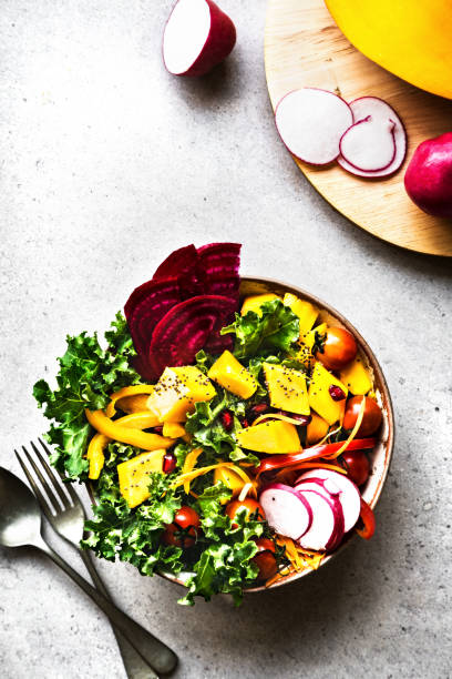 istock Mango with Kale,Radish and Pomegranate salad bowl 1281592702