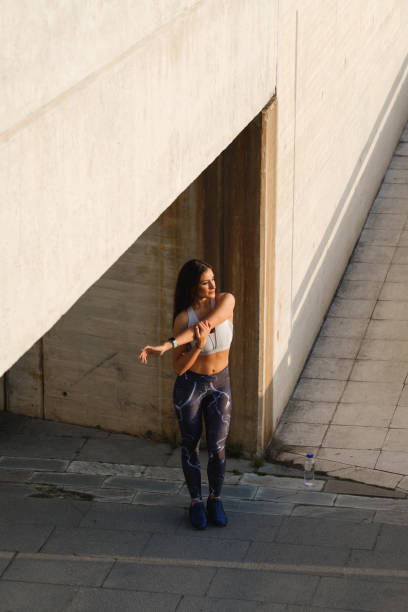 istock Female athlete doing stretching shoulder and arm exercise 1281592924