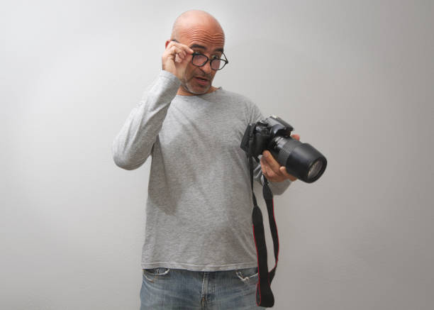 istock Attractive dark-haired bald man with three-day beard, gesturing and  glad to take good photos 1281594671