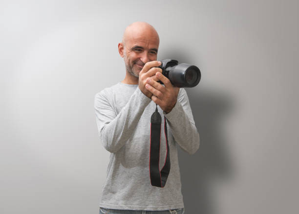 istock Attractive dark-haired bald man with three-day beard, gesturing and  glad to take good photos 1281594724