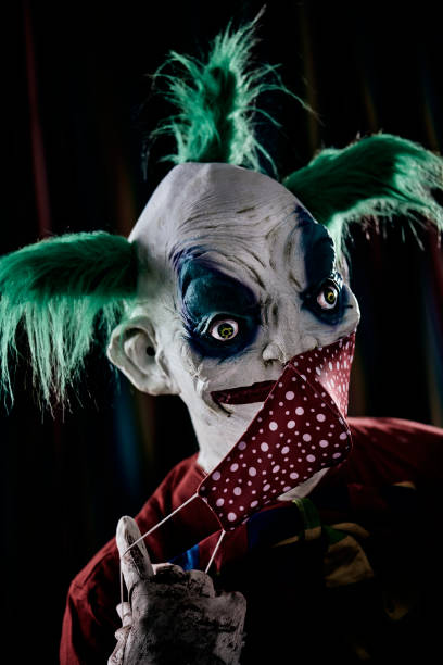 istock disturbing evil clown wearing a face mask 1281594761