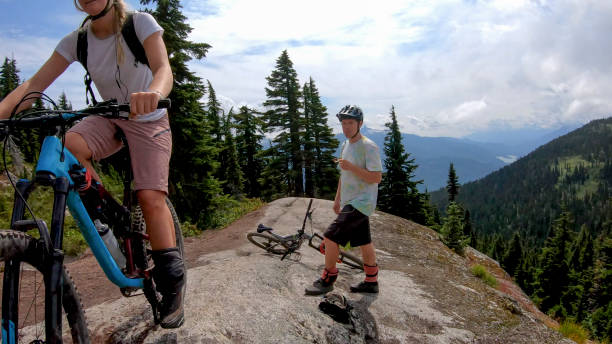istock Mountain bikers ride along alpine trail 1281595323