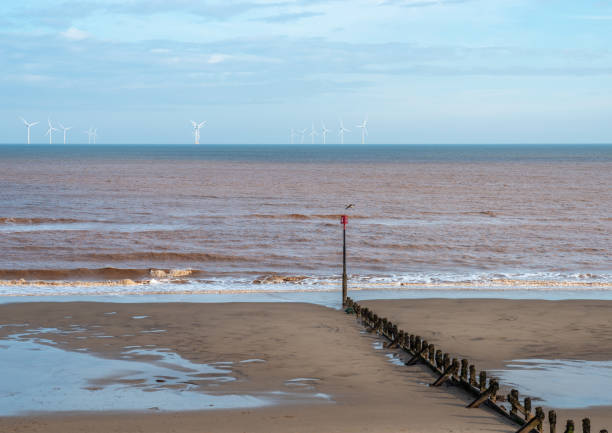 istock Beach groin leading to wind farm 1281595396