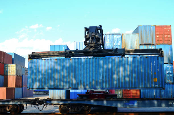 istock Shipping container loading by richtracker on the freight rail car at logistic warehouse port 1281595830