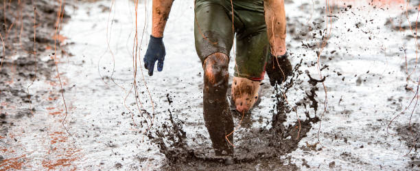 istock Low Section Of Man Running In Mud 1281595916