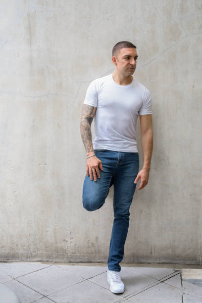 istock Full body shot of handsome man with tattoos thinking 1281596146