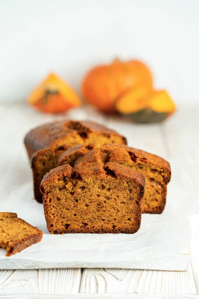 istock Pumpkin bread cake with half loaf sliced on white wooden background 1281596595