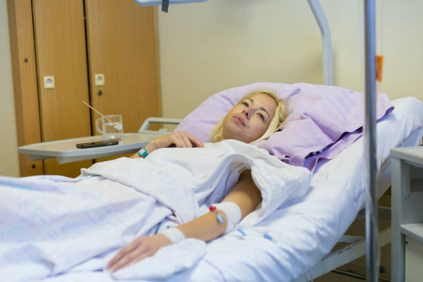 istock Woman Lying On Bed In Hospital 1281596740