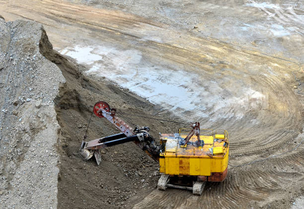 istock Excavator with electric shovel loading the rocks in mining truck at quarry. 1281596836