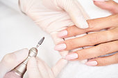 Classic pink wedding nail manicure on white backdrop. Spa treatment concept