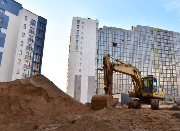 istock Excavator working at construction site. Backhoe on road work and earthworks 1281598450