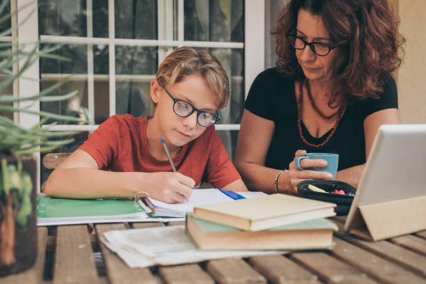 istock Mother Assisting Son In Homework At Home 1281600329