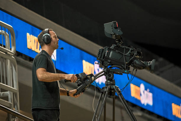 istock Cameraman operating camera in court 1281602154