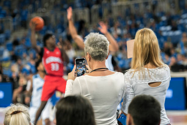 istock Spectators photographing during the match 1281602157