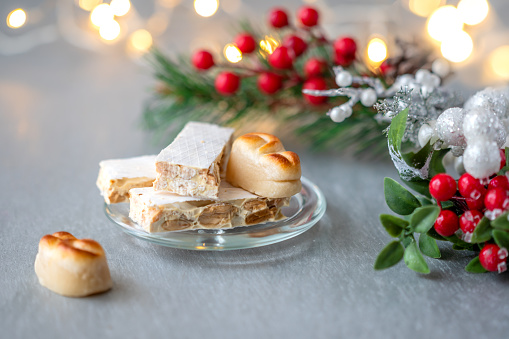 Spanish Christmas sweets turron, marzipan and bright light in the background
