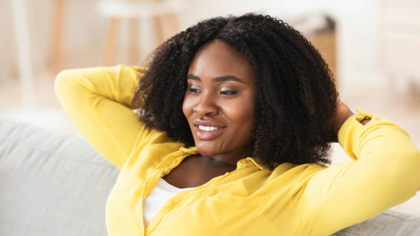 istock Black woman having rest at home on the sofa 1281608036