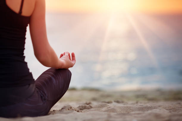 istock Young woman sitting on the beach 1281608997