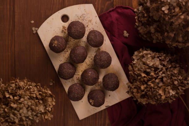 istock Cocoa balls, chocolate truffles cakes on board on wooden background 1281609218