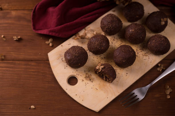 istock Cocoa balls, chocolate truffles cakes on board on wooden background 1281609229