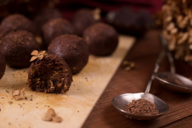istock Cocoa balls, chocolate truffles cakes on board on wooden background 1281609233