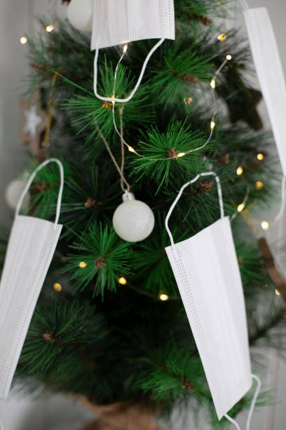 istock Christmas tree decorated with white face masks for Covid and Coronavirus, Covid-19 concept 1281609721