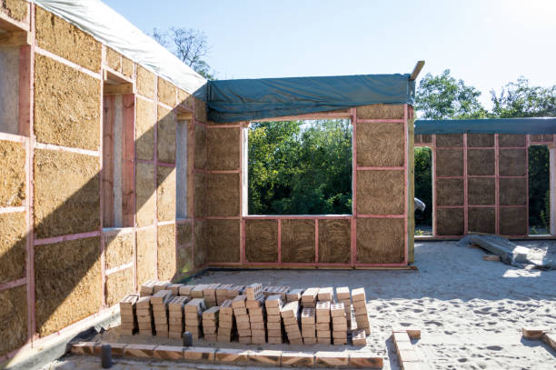 Construction of a house from an environmentally friendly material of plant origin. Frame made of wood, blocks of straw. Construction of a house from an environmentally friendly material of plant origin. Frame made of wood, blocks of straw. adobe material stock pictures, royalty-free photos & images