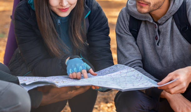 istock Three unrecognizable friends holding map, got lost at countryside 1281611348