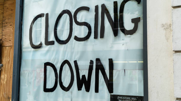 istock Closing down sign in a boarded-up shop window 1281612027