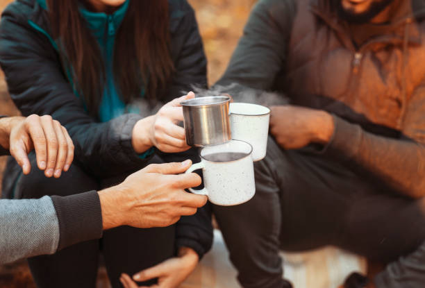 istock Hands of hikers cheering up with camping cups 1281613712