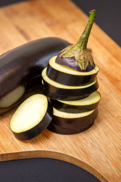 istock Eggplant on wooden cutting board 1281614047