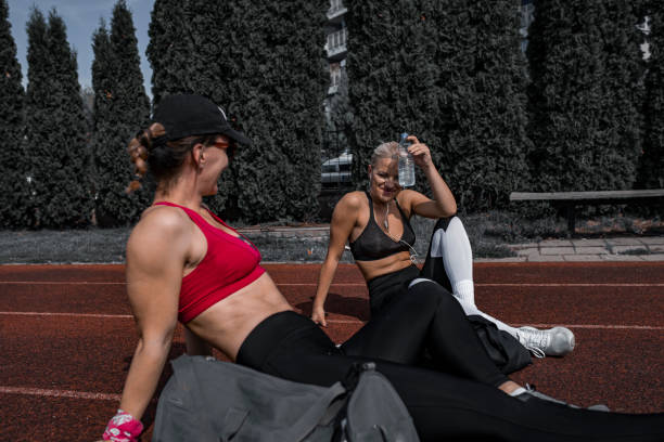 istock Two female athlethes resting after strong workout outdoors in summertime 1281617581