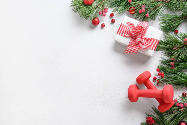istock Christmas composition with red dumbbells and gift on white. 1281617890
