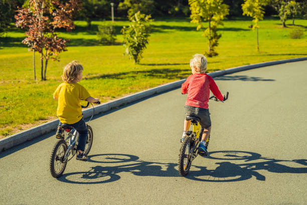 istock Two happy boys cycling in the park 1281617914
