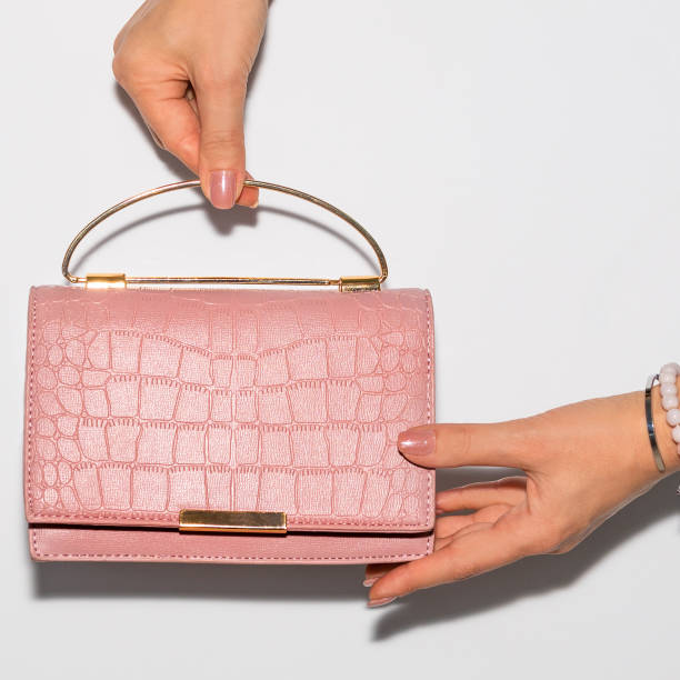 istock Woman holding pink leather handbag 1281619215